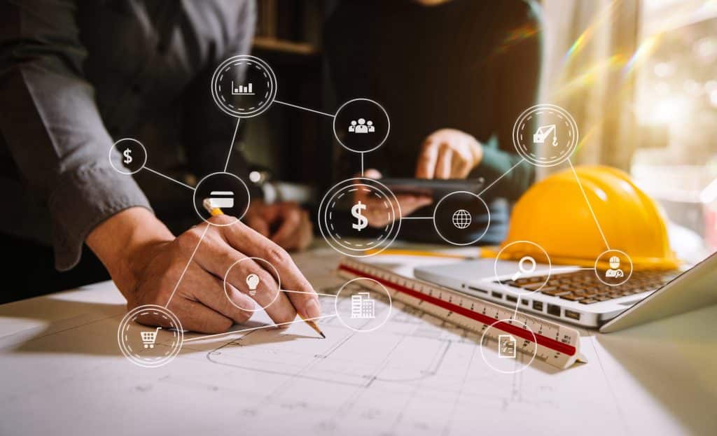 Two colleagues discussing data working and tablet, laptop with on on architectural project at construction site