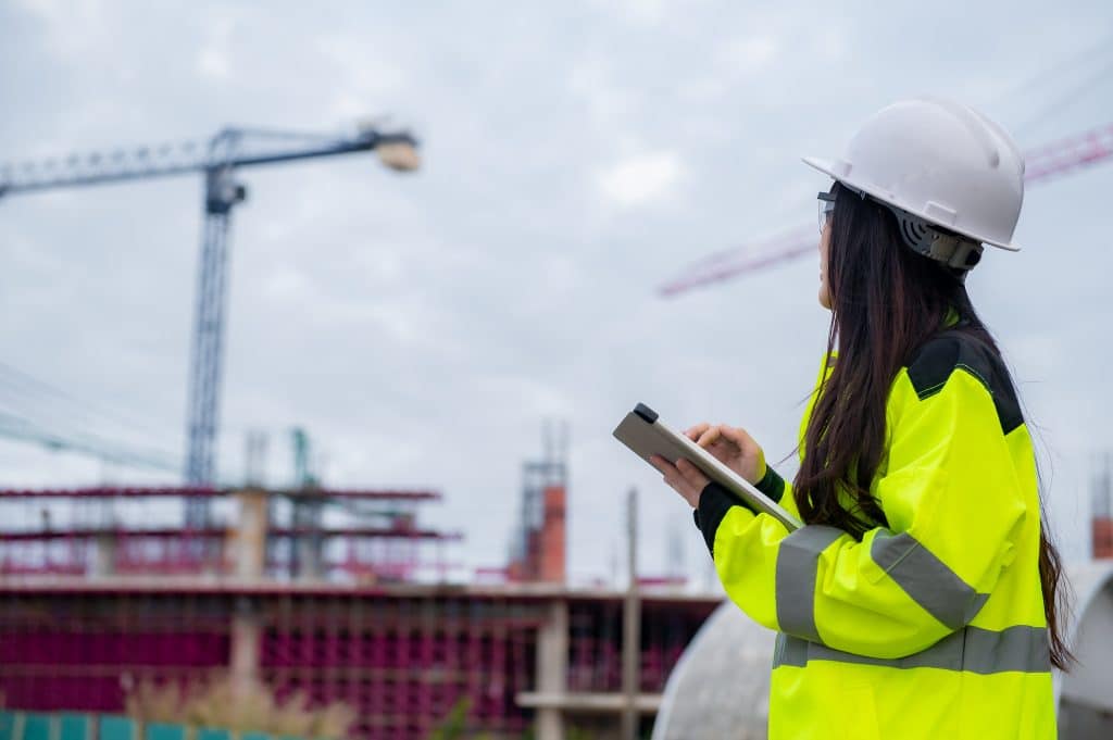 woman engineer working at site of a large building project,Thail